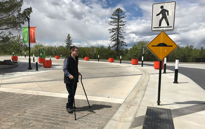 Niek Theelen, Stand-up Comedian, Web Designer and Filmmaker (Blackfalds), approaches the wide sidewalk at Canada 150 Square in Capstone.