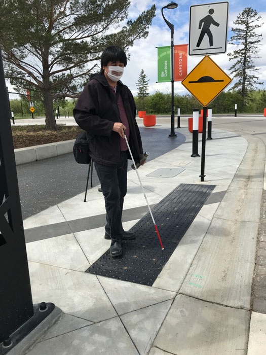 J.R. Bjornson of Blind Guy Comedy (Red Deer)  uses the tactile surface indicators installed for  the visually impaired